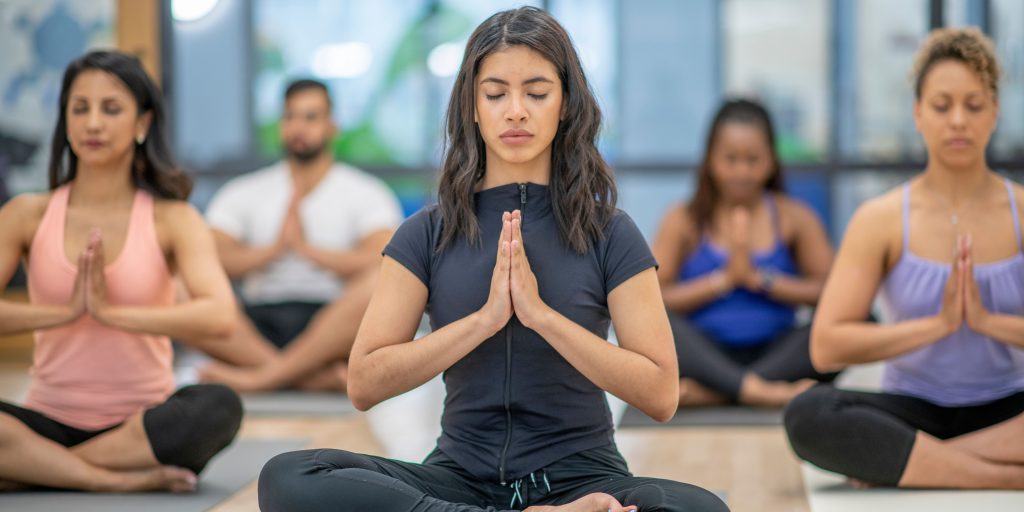 Women in yoga class reducing stress